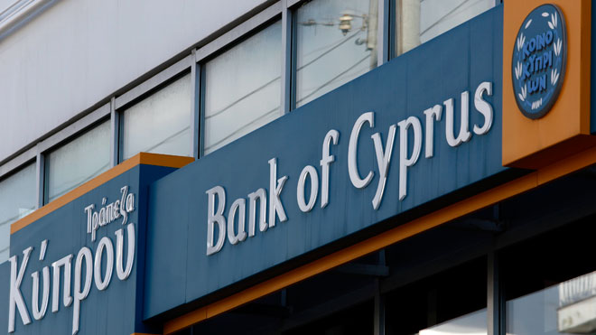 Cyprus reopens banks under tight restrictions